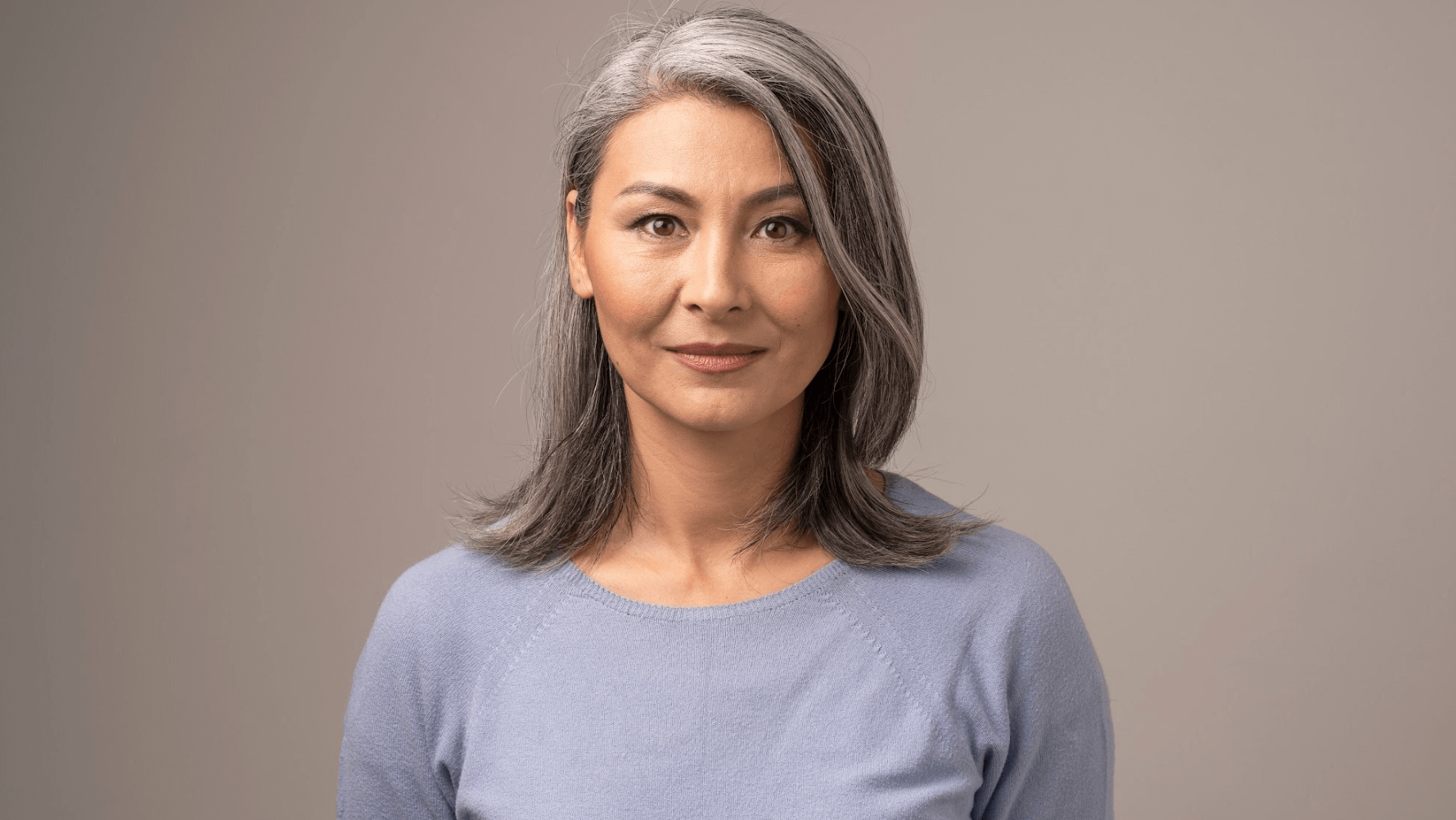 older woman in grey shirt